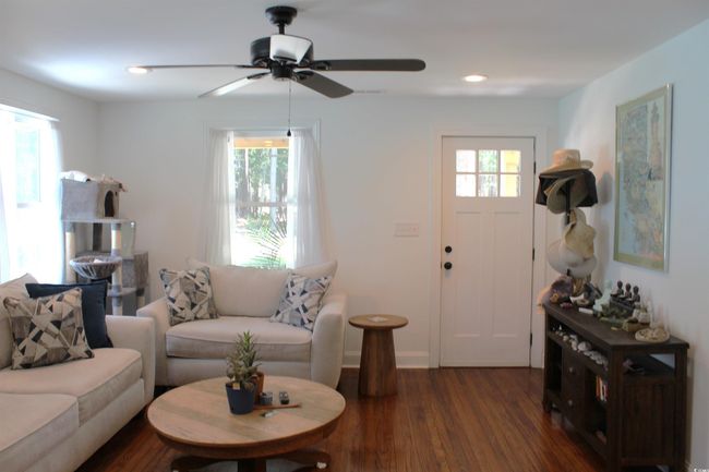 Living room with healthy amount of natural light, ceiling fan, dark wood-style floors, and recessed lighting | Image 6