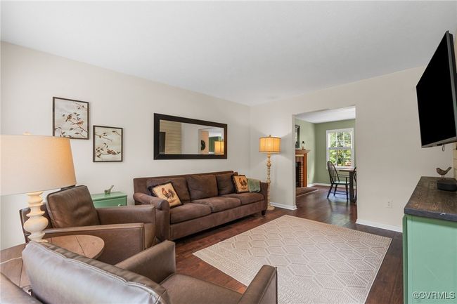 Living area with baseboards and dark wood-style flooring | Image 13