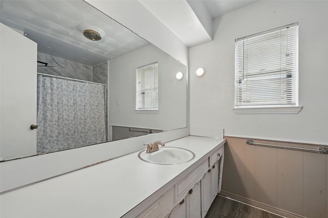 Bathroom with vanity, wood finished floors, curtained shower, and a wainscoted wall | Image 21