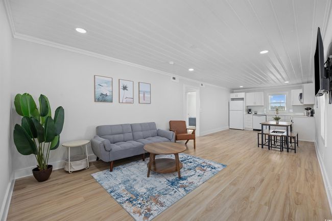 Living area with recessed lighting, ornamental molding, light wood-type flooring, and baseboards | Image 30
