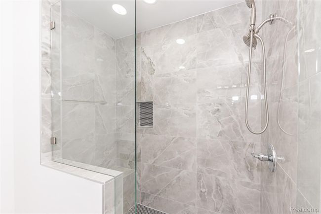 Extended lavish tile shower with a seating bench | Image 13