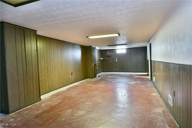 Basement with wood walls and visible vents | Image 36