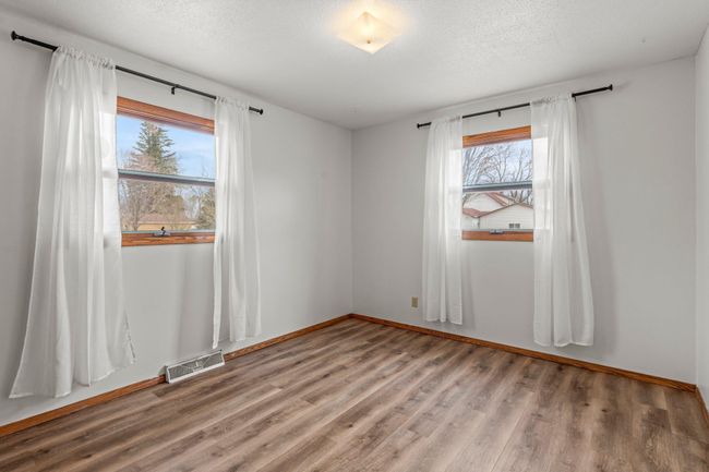Both bedrooms are located on the main floor and are similar in size, each featuring LVP flooring and ample closet space. | Image 6