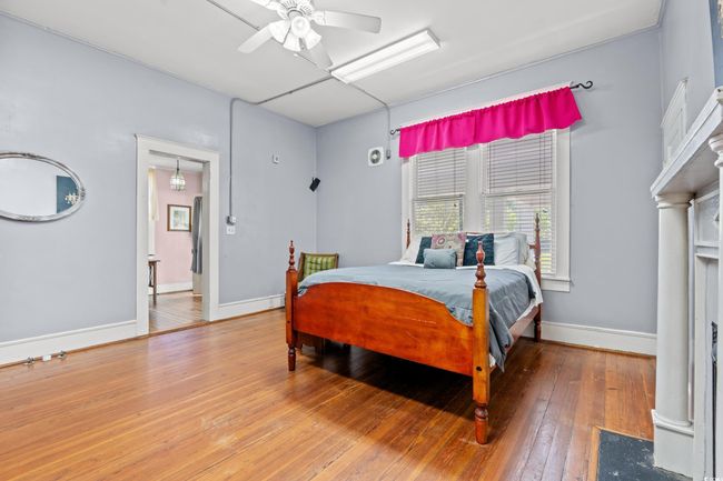 Bedroom with wood-type flooring and a ceiling fan | Image 14