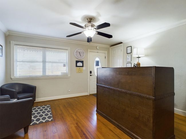 Welcome area with ornamental molding and a ceiling fan | Image 9