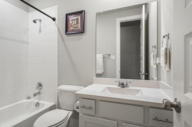 Full bathroom with vanity, tiled shower / bath, and toilet | Image 11