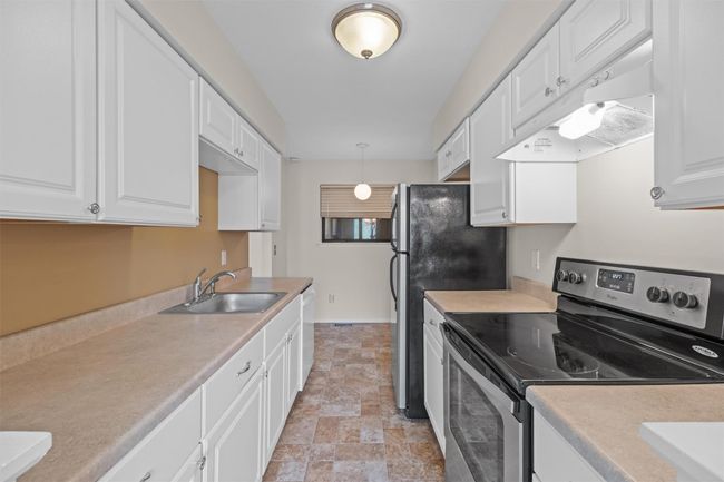 Galley style kitchen with stainless steel appliances | Image 11