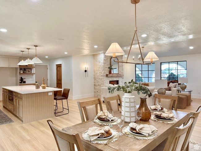 Dining room with recessed lighting, light wood-style flooring, and a chandelier | Image 9