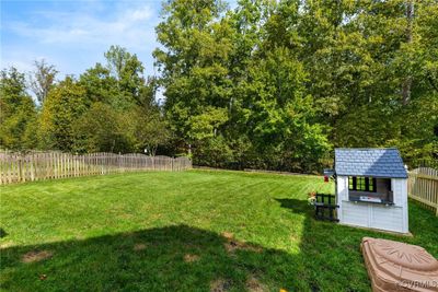 The backyard offers lots of space for play, and backs up to a private wooded area. | Image 3