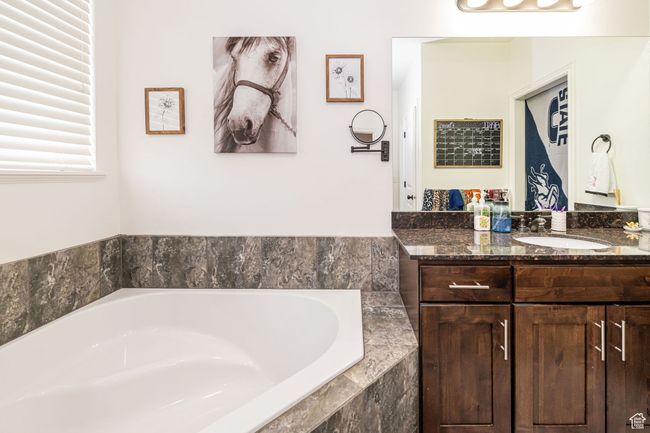 Bathroom with a bath and vanity | Image 15
