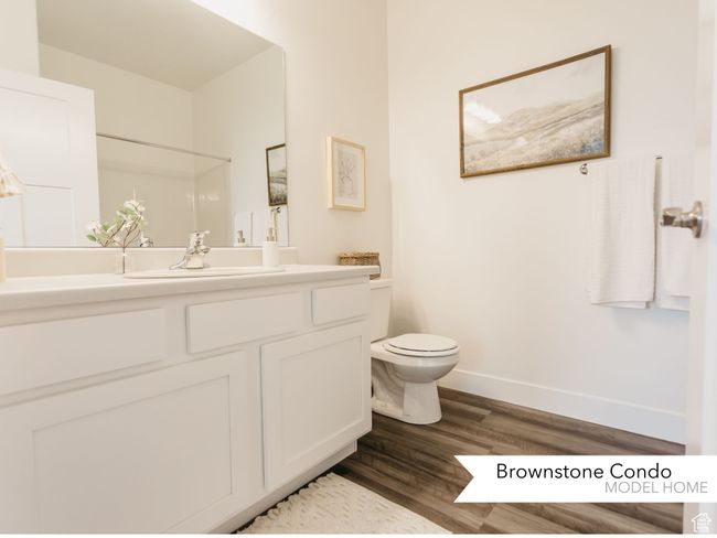 Bathroom with toilet, vanity, wood finished floors, and baseboards | Image 12