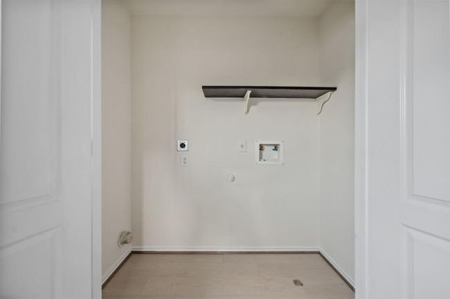 Upstairs laundry room with storage space and tile flooring. | Image 22