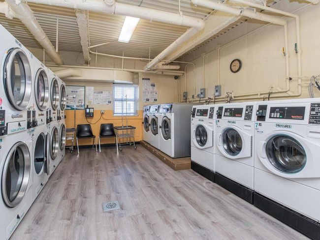 Shared laundry room with stacked washer and clothes dryer, independent washer and dryer, and light wood finished floors | Image 7