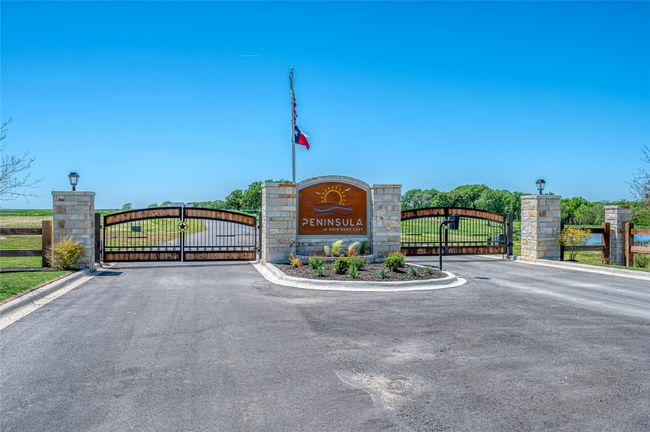 Community / neighborhood sign with a gate and fence | Image 4