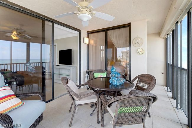 Tiled dining space featuring a water view, ceiling fan, and ornamental molding | Image 25