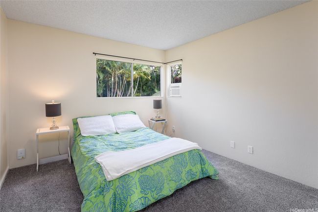 Bedroom #1 with new paint (ceiling too), carpet, window AC, and mirrored closet doors. | Image 12