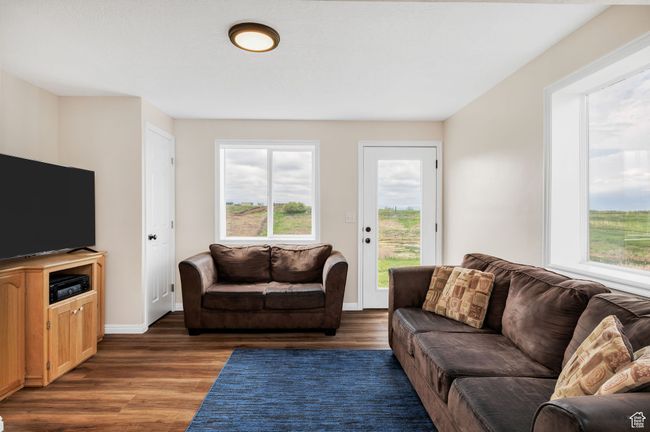 Basement walk out Living area featuring wood finished floors and baseboards. Plumbed for a kitchenette | Image 17