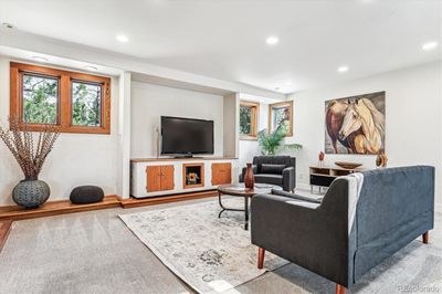 Wonderful room for gatherings with custom entertainment built-in reminiscent of the mid century. | Image 3