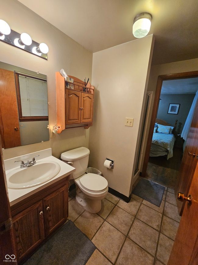 bathroom featuring vanity, connected bathroom, and tile patterned floors | Image 23