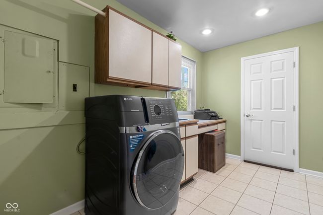 Spacious mud/laundry room with additional pantry storage and utility sink | Image 19