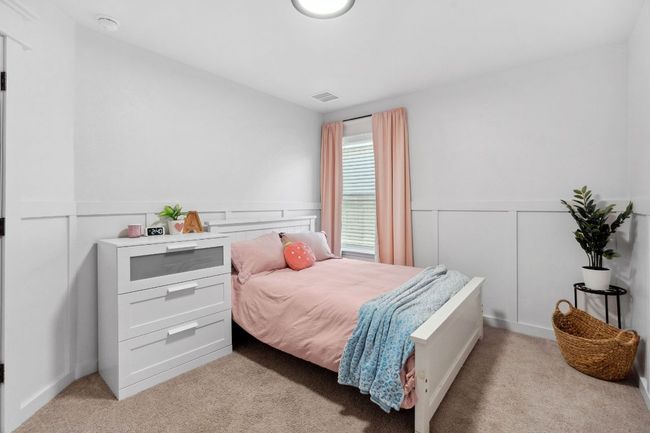 The second bedroom features board and batten wall details. | Image 25