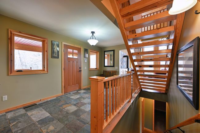 Stairs lead to the lower walkout level as well as the loft above. | Image 16