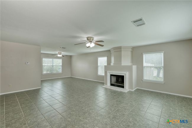 View of main living area to dining room. Notice the abundance of natural light. | Image 9