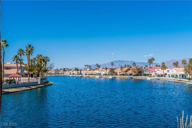 Water view with nearby suburban area and a mountainous background | Image 49