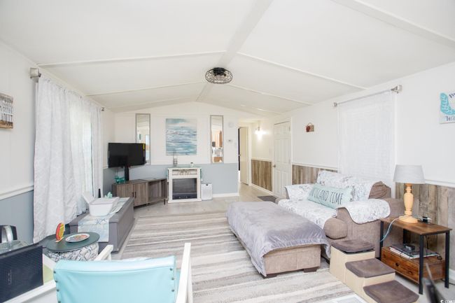 Living room with lofted ceiling | Image 10