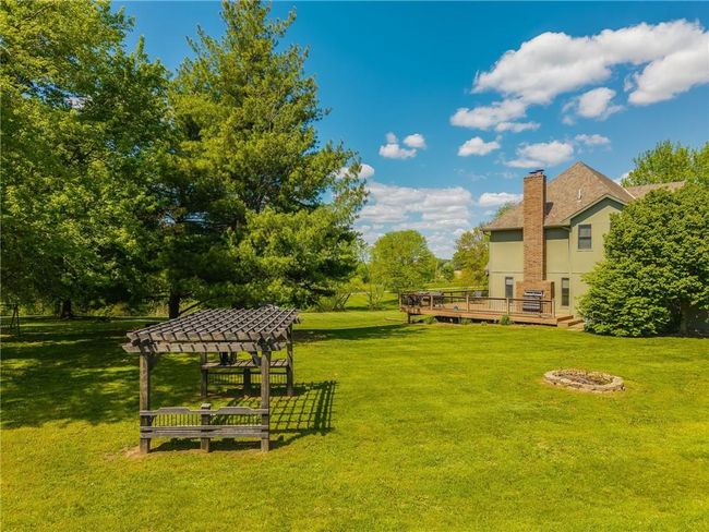 View of yard featuring a wooden deck | Image 17