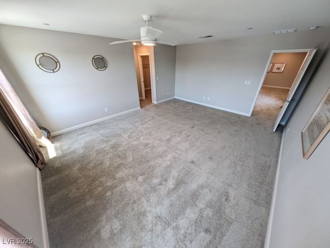 Carpeted empty room featuring a ceiling fan and baseboards | Image 20