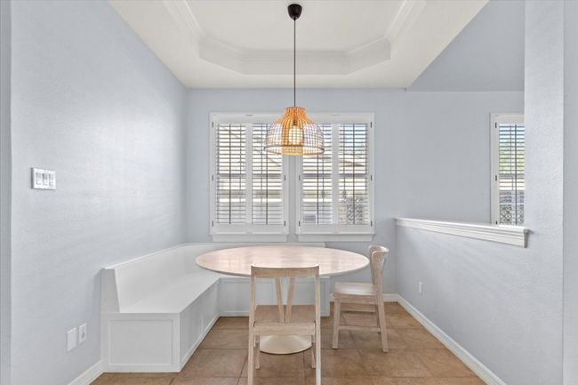 This cozy breakfast nook has built-in bench seating, making it the perfect spot for family game night. | Image 15
