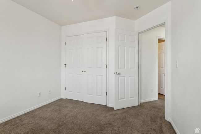 Unfurnished bedroom featuring carpet floors, a closet, and baseboards | Image 17