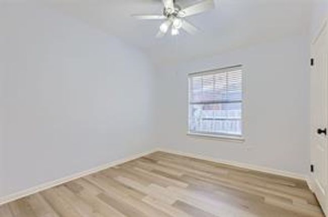 Empty room with wood finished floors and a ceiling fan | Image 18