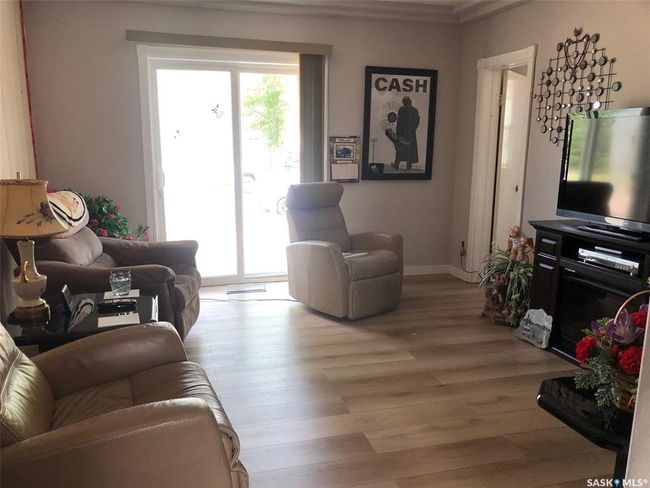 Living room featuring light wood-style floors and crown molding | Image 27