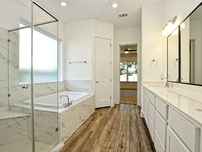 Bathroom with a garden tub, double vanity, wood finished floors, a marble finish shower, and recessed​​‌​​​​‌​​‌‌​‌‌​​​‌‌​​‌‌​‌​​​​​‌ lighting | Image 18