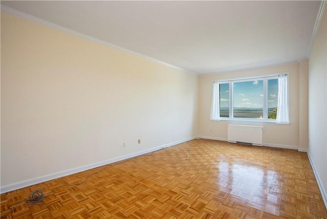 Besides the unobstructed panoramic Hudson River views, this primary Bedroom also boasts beautiful parquet floors, fresh paint, moldings, and a walk-in dressing area with massive storage storage space. dressing | Image 18