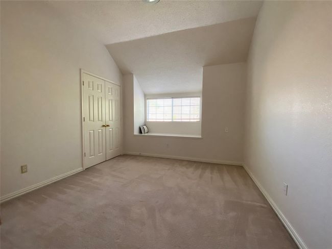 Carpeted spare room with a textured ceiling and vaulted ceiling | Image 27