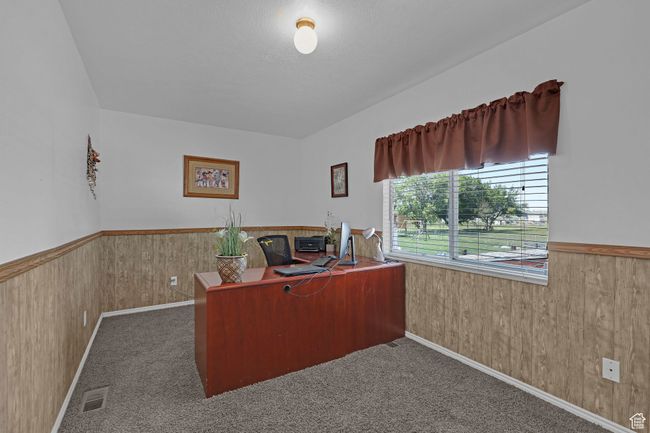 Carpeted office space with a wainscoted wall and wooden walls | Image 20