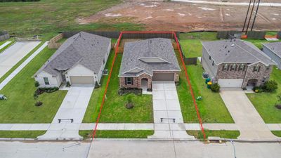 This home sits on a large lot with ample yard space in front and the back, lush landscaping and a well-maintained yard. | Image 2