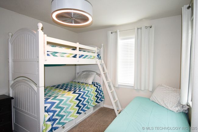 Carpeted bedroom featuring multiple windows and baseboards | Image 21