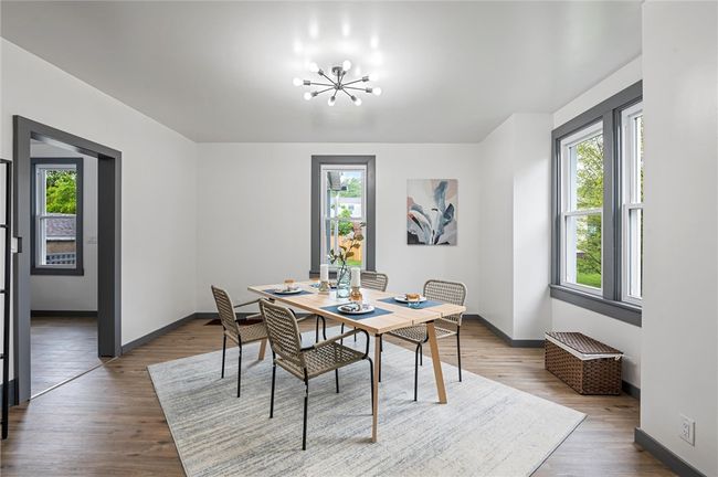 A spacious separate dining room continues the home’s modern look with high ceilings and coordinating laminate floors. | Image 6
