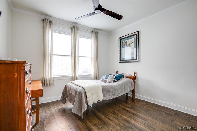 Bedroom featuring dark hardwood / wood-style floors, crown molding, and ceiling fan | Image 37