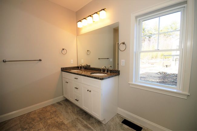 Upgraded tile floor, standard Granite counter top with double sink vanity. | Image 16