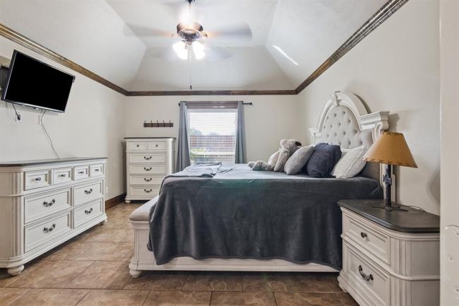 Primary bedroom with tray ceiling and beautiful crown molding. | Image 21
