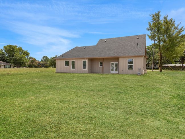 Back of house featuring french doors, a shingled roof, and a yard | Image 26