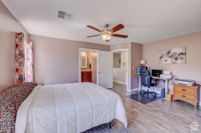 Bedroom featuring wood finished floors, visible vents, baseboards, and ceiling fan | Image 18