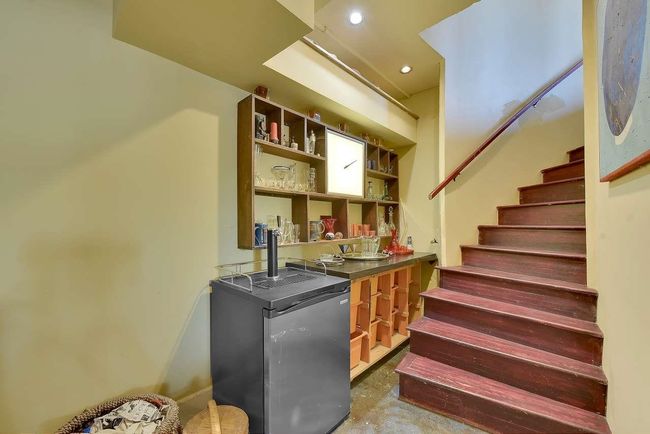 Indoor wet bar featuring stairway, concrete floors, recessed lighting, and fridge | Image 20
