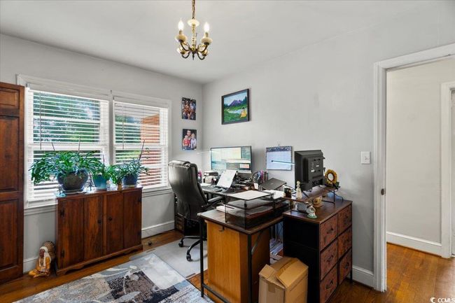 Office featuring a chandelier and wood finished floors | Image 22