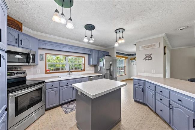 Kitchen featuring a sink, plenty of natural light, appliances with stainless steel finishes, and light floors | Image 10